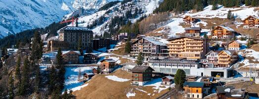 Aerial View of Murren, Switzerland  Chalets and Snow Capped Mountains photo