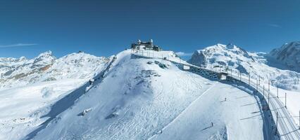 aéreo ver de zermatt esquí complejo, Suiza con tren y esquiadores foto