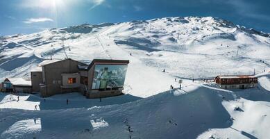 Sunny Day at Zermatt Ski Resort, Swiss Alps with Snowy Slopes and Red Train photo