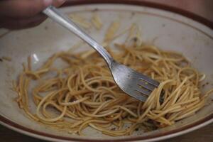 fried noodles on a plate with a fork photo