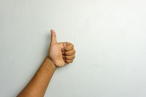 male hand showing thumbs up gesture. thumbs up sign isolated on white photo