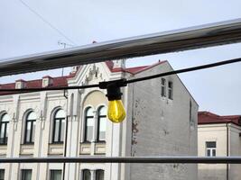 Light bulb against the background of the city. Light bulb on the street photo