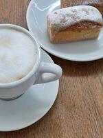 Coffee and cake. Cup with coffee and cupcake. Sweet pastries. Tasty breakfast photo