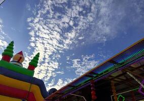 Inflatable plastic slide, low angle photo, sky background photo