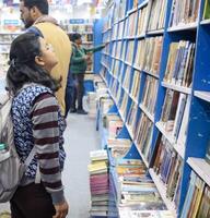 New Delhi, India, February 17 2024 - Variety of Books on shelf inside a book-stall at Delhi International Book Fair, Selection of books on display in Annual Book Fair at Bharat Mandapam complex photo