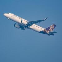 New Delhi, India, December 25 2023 - Vistara Airbus A320 neo take off from Indra Gandhi International Airport Delhi, Vistara domestic aeroplane flying in the blue sky during day time photo