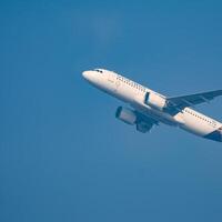 New Delhi, India, December 25 2023 - Vistara Airbus A320 neo take off from Indra Gandhi International Airport Delhi, Vistara domestic aeroplane flying in the blue sky during day time photo