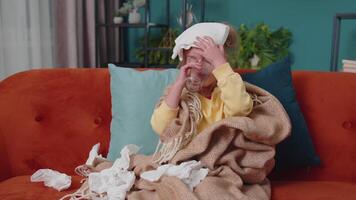 Child girl in plaid suffering from cold or allergy, drinking medicine pill tablet water at home room video