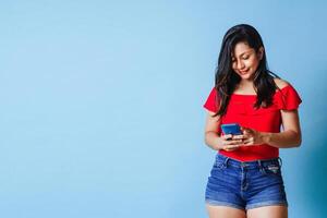 hispanic young woman using mobile indoor studio. Communication concept. photo