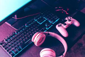 Top view of mouse,keyboard, joystick and headset over black background. gamer work space concept. photo