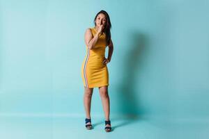 Hispanic woman make hush gesture with a finger. photo