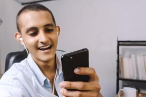 portrait of a young latinx using a mobile smart phone. technology concept. photo