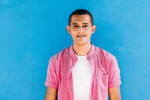 young hispanic man smiling at camera. photo