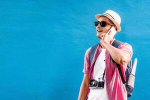 happy adult man traveler holding his phone, making a call photo