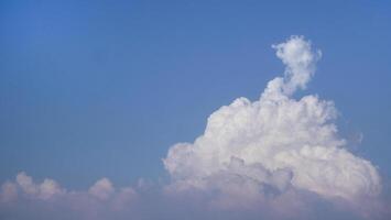 White fluffy clouds open for fantasy idea shape against bright blue sky for background with copy space, graphic resource, cloud motion from the wind photo