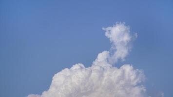 White fluffy clouds open for fantasy idea shape against bright blue sky for background with copy space, graphic resource, cloud motion from the wind photo