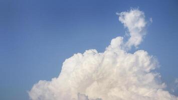 White fluffy clouds open for fantasy idea shape against bright blue sky for background with copy space, graphic resource, cloud motion from the wind photo