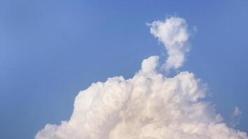 White fluffy clouds open for fantasy idea shape against bright blue sky for background with copy space, graphic resource, cloud motion from the wind photo