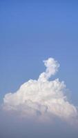 White fluffy clouds open for fantasy idea shape against bright blue sky for background with copy space, graphic resource, cloud motion from the wind photo