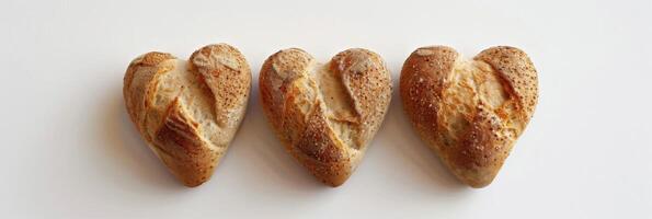 AI generated Three heart-shaped baked bread loaves with sesame seeds express love and artisan bakery craftsmanship photo