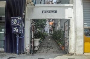 a narrow alley in the middle of Surabaya city called Jalan Tunjungan 1, Indonesia, 2 March 2024. photo