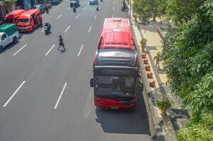 a rapid transit public transportation Suroboyo Trans Semanggi Bus which stops at a bus stop, Indonesia, 2 March 2024. photo