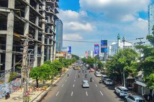 landscape of Surabaya city streets from the pedestrian bridge during the day, Indonesia, 2 March 2024. photo