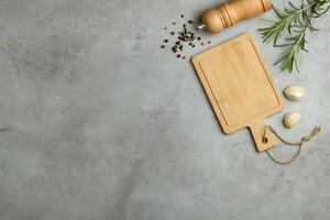 Mock up for restaurant menu or recipe. Wooden cutting board with salt and pepper on the gray rustic background. Copy space. Top view. photo
