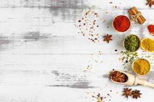 Top view of various spices in bowls isolated on white background. Copy space. photo