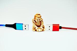 Buddhist monk,modern technology Connect and chat. Red and blue usb cables photo