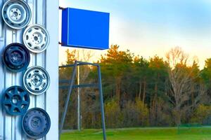 Car station. Metal car rims hanging on the wall photo