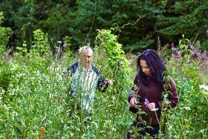 Hiking.A young woman, an elderly man are walking.Blooming spring thickets photo