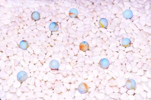 Pale pink stones,glass gem blue balls background photo