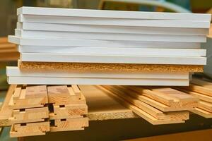 Sheets of plywood, boards, lumber stacked in rows in a carpentry in a warehouse photo