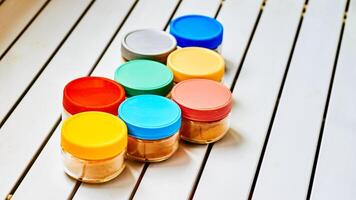 spice storage containers. containers on a white striped table. photo