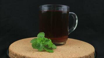 rotating display of green tea on black background. video