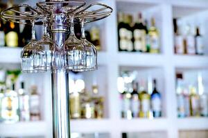 Wine glasses hanging on bar counter in a cafe or restaurant photo