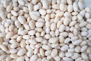 Fresh beans on table background, ready for cooking photo