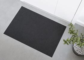 Sleek black doormat mockup in a contemporary setting, perfect for displaying logos or custom prints in a home or office entrance. Welcome mat with copy space. Doormat mock up. Carpet at entrance. 3D. photo