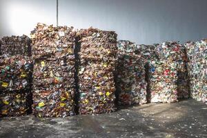 Plastic bales of rubbish at the waste treatment processing plant. Recycling separatee and storage of garbage for further disposal, trash sorting. Business for sorting and processing of waste. photo