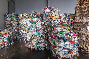 plastic pressed bales at the modern waste hazardous processing plant. Separate garbage collection. Recycling and storage of waste for further disposal. Business for sorting and processing of waste. photo