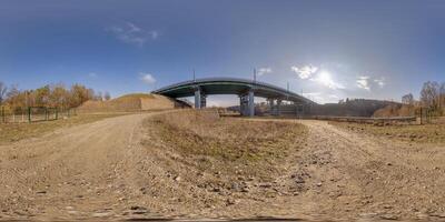 hdri 360 panorama on gravel road near steel frame construction of huge car bridge across river  in equirectangular full seamless spherical projection. VR  AR content photo