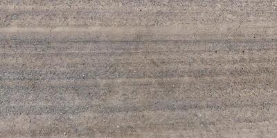 view from above on texture of gravel road with car tire tracks photo