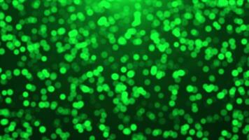 bellissimo verde luccichio particelle caduta e tremolante particelle al di sopra di nero sfondo, semplice particelle sfondo video