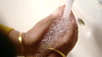 child making a cleansing gesture with soap and water on hands video