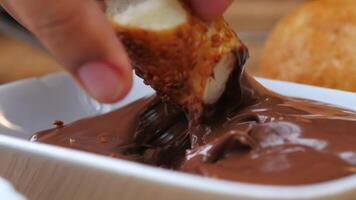 a bowl of chocolate cream and bread on a table video