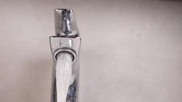 water pouring from a faucet tap slow motion video