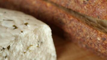 close up of fresh herb cheese and breads on table video