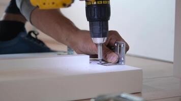 slow motion of using electric drilling on white wooden board video