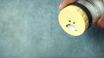 Person holds blue salt shaker with sad face video